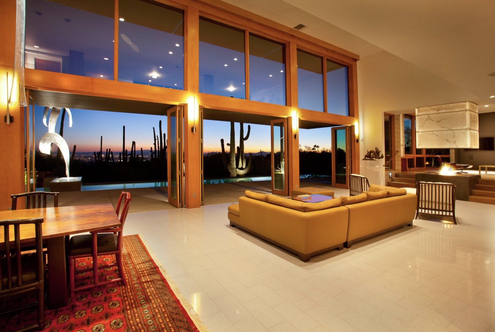 Outswing multi‑panel bi‑fold doors, living room, desert night