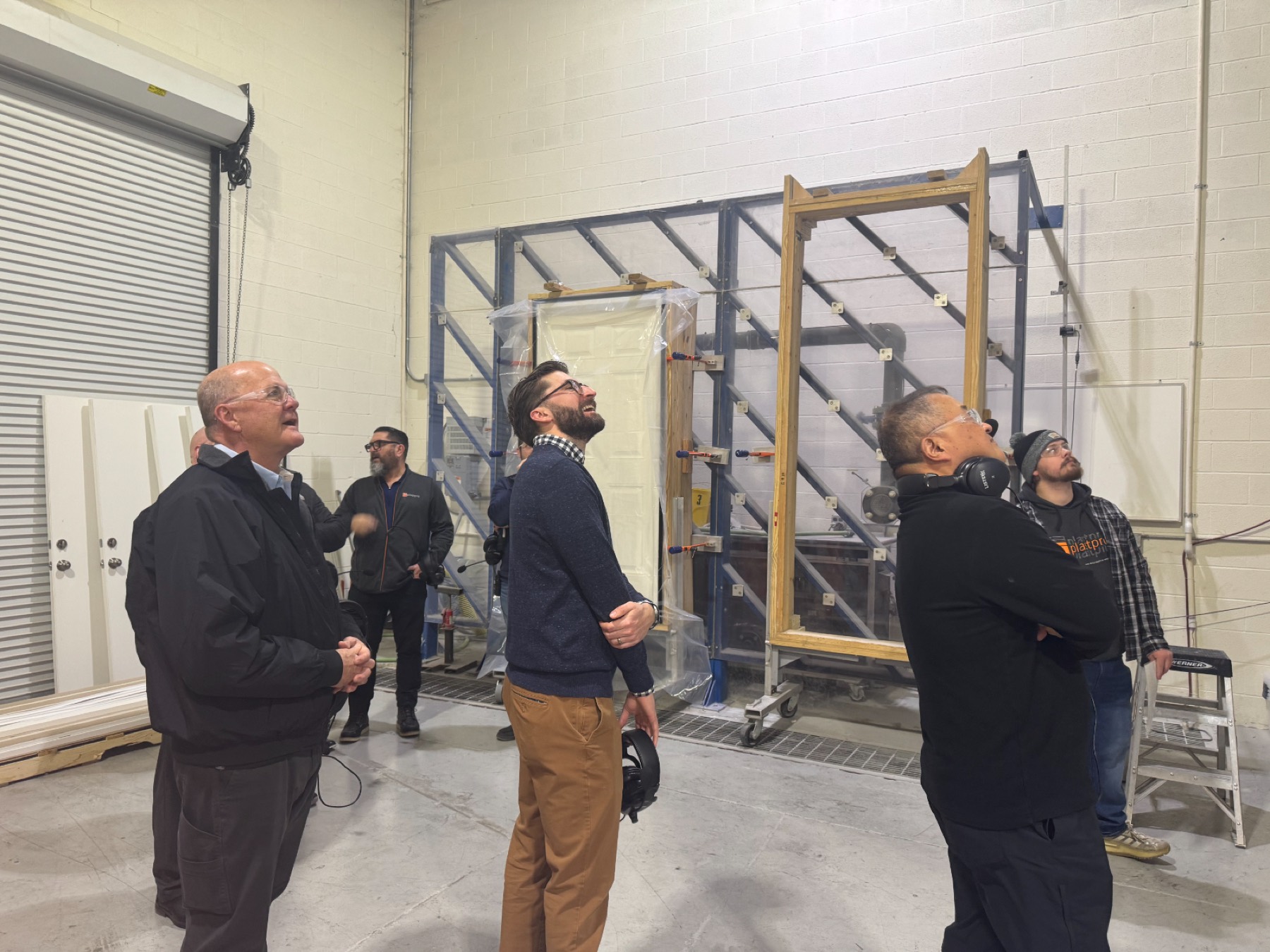 Michael Tull and the Do it Best team in the hurricane testing room at the Plastpro fiberglass door plant, January 2026